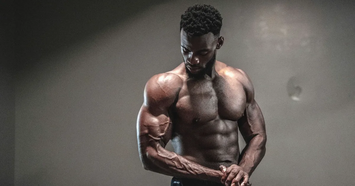 Muscular bodybuilder in dramatic studio lighting showing a conditioned physique
